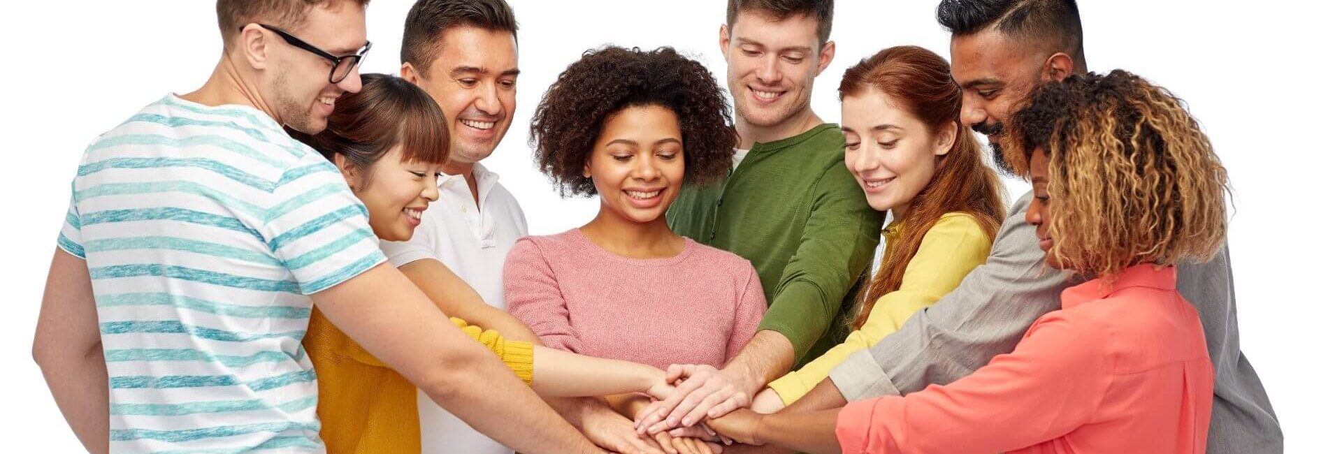 A diverse group joining hands in unity.
